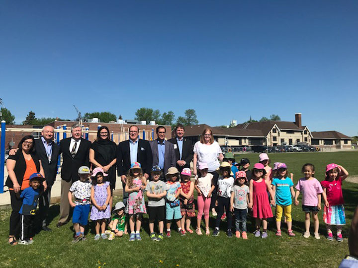 Families Minister Heather Stefanson (fourth from left, back row) announced government support for the new Assiniboine Childrens Centre building and renovations to Ecole Assiniboine School.